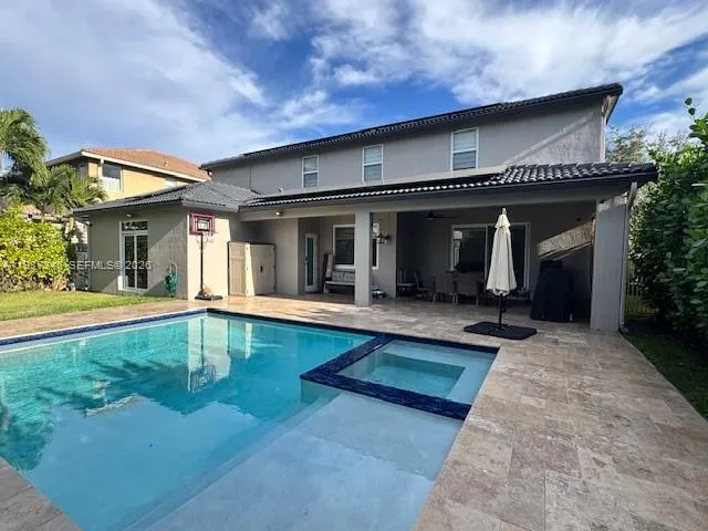 a view of a house with swimming pool and sitting area