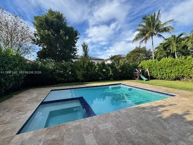 a view of swimming pool with a yard