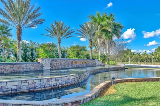 a view of a swimming pool with a patio and a yard