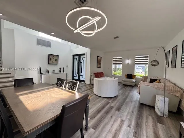 a living room with furniture a rug and white walls
