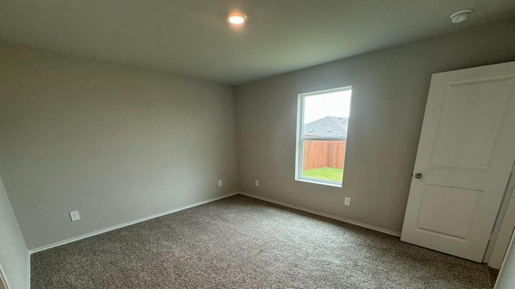 5541 Flannel Lane Krum, TX 76249 - Photo 3 of 13 an empty room with a window and doors