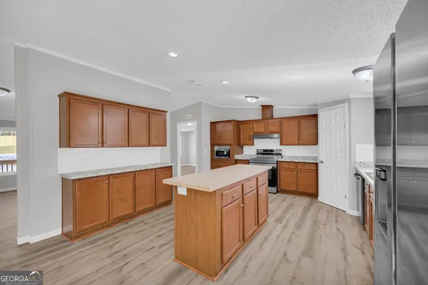 a kitchen with stainless steel appliances granite countertop a sink stove and refrigerator