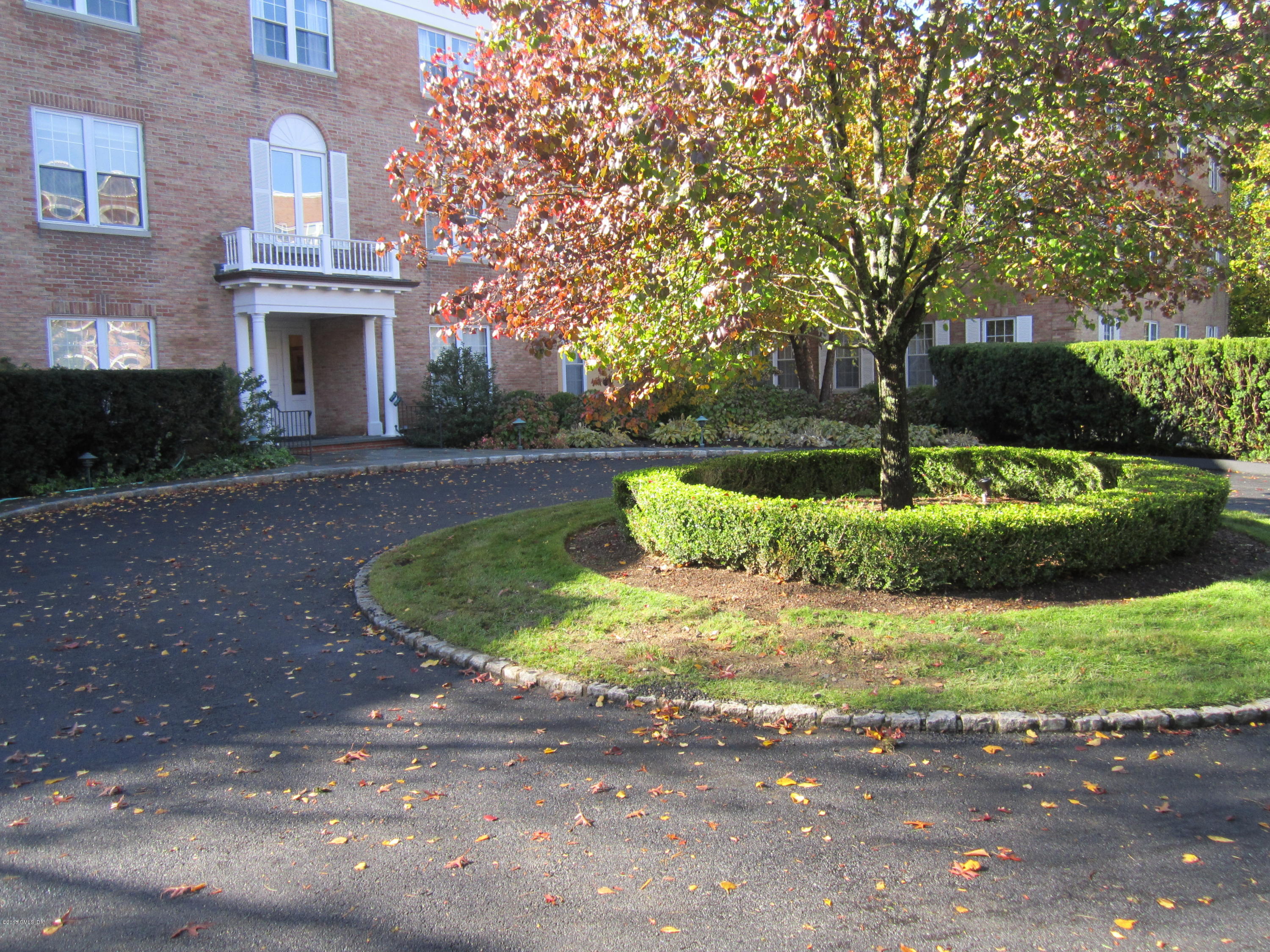 140 Field Point Road, Unit 21 Greenwich, CT 06830 - Photo 1 of 12 a front view of a house with a yard