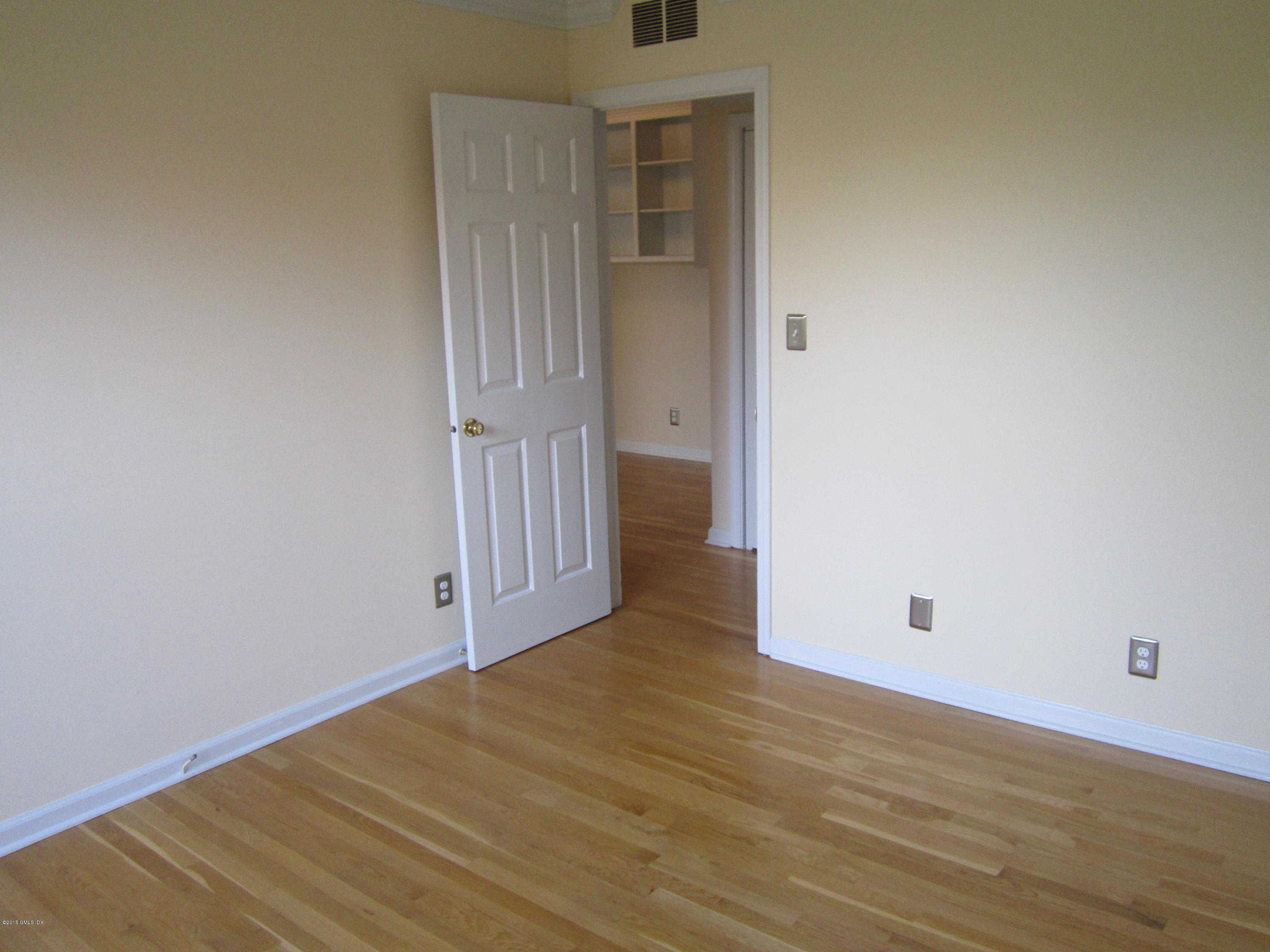 140 Field Point Road, Unit 21 Greenwich, CT 06830 - Photo 12 of 12 an empty room with wooden floor and entryway