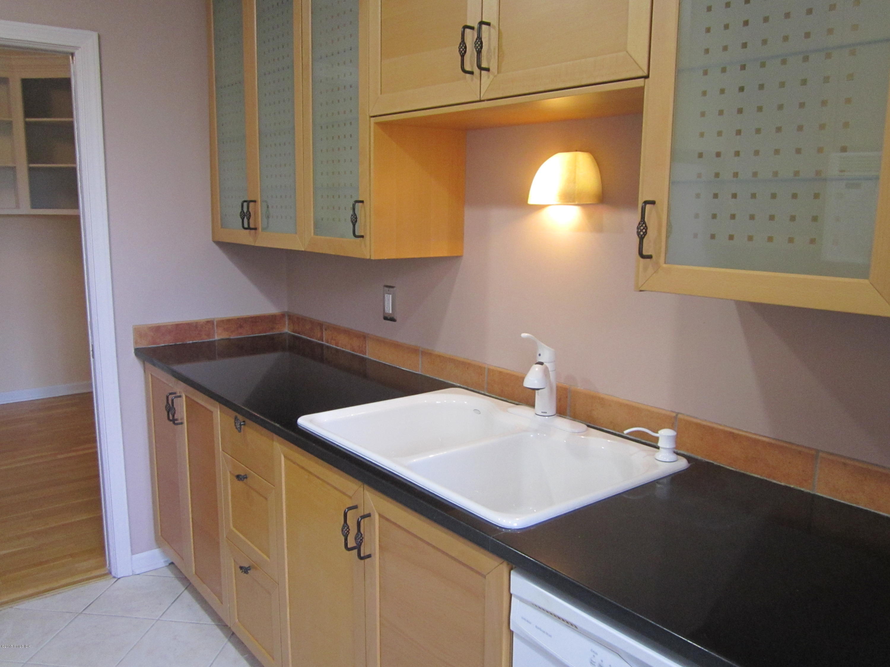 140 Field Point Road, Unit 21 Greenwich, CT 06830 - Photo 8 of 12 a kitchen with a sink and cabinets