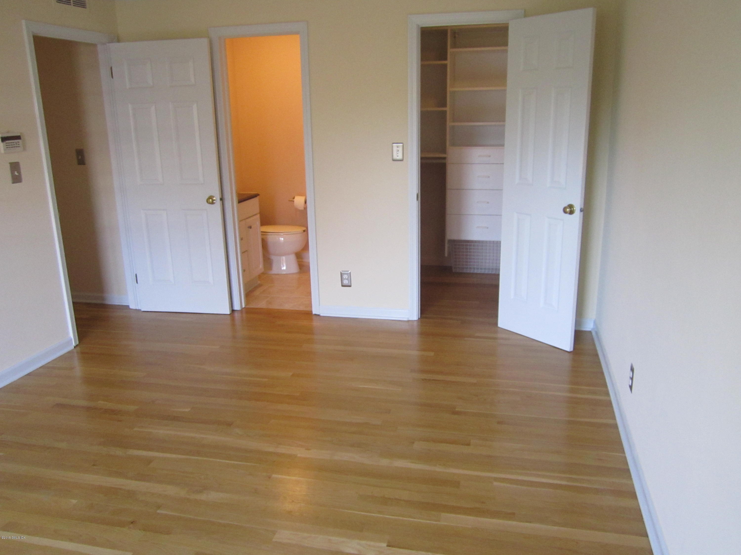 140 Field Point Road, Unit 21 Greenwich, CT 06830 - Photo 9 of 12 wooden floor in an empty room