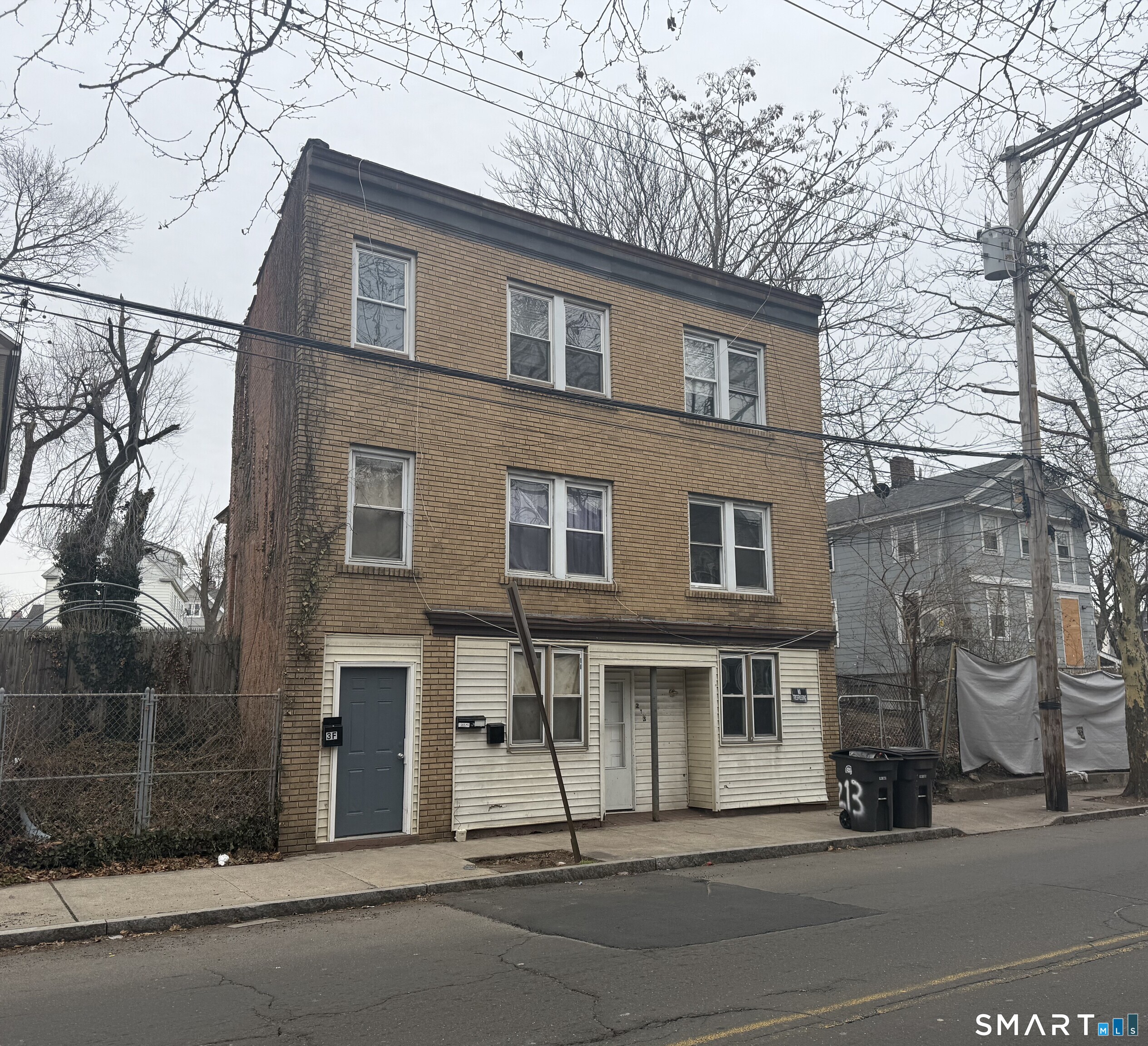 a view of a brick building next to a road