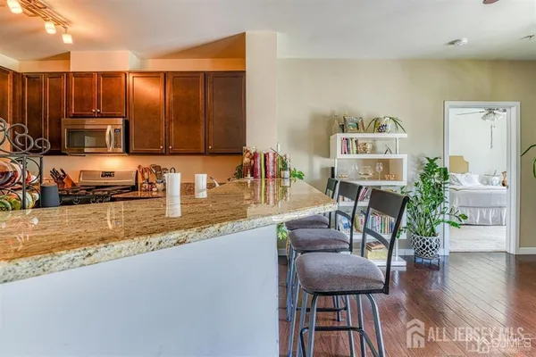 a kitchen with a table chairs refrigerator and cabinets
