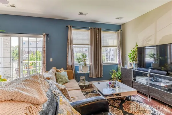 a bedroom with a bed a large window and couch