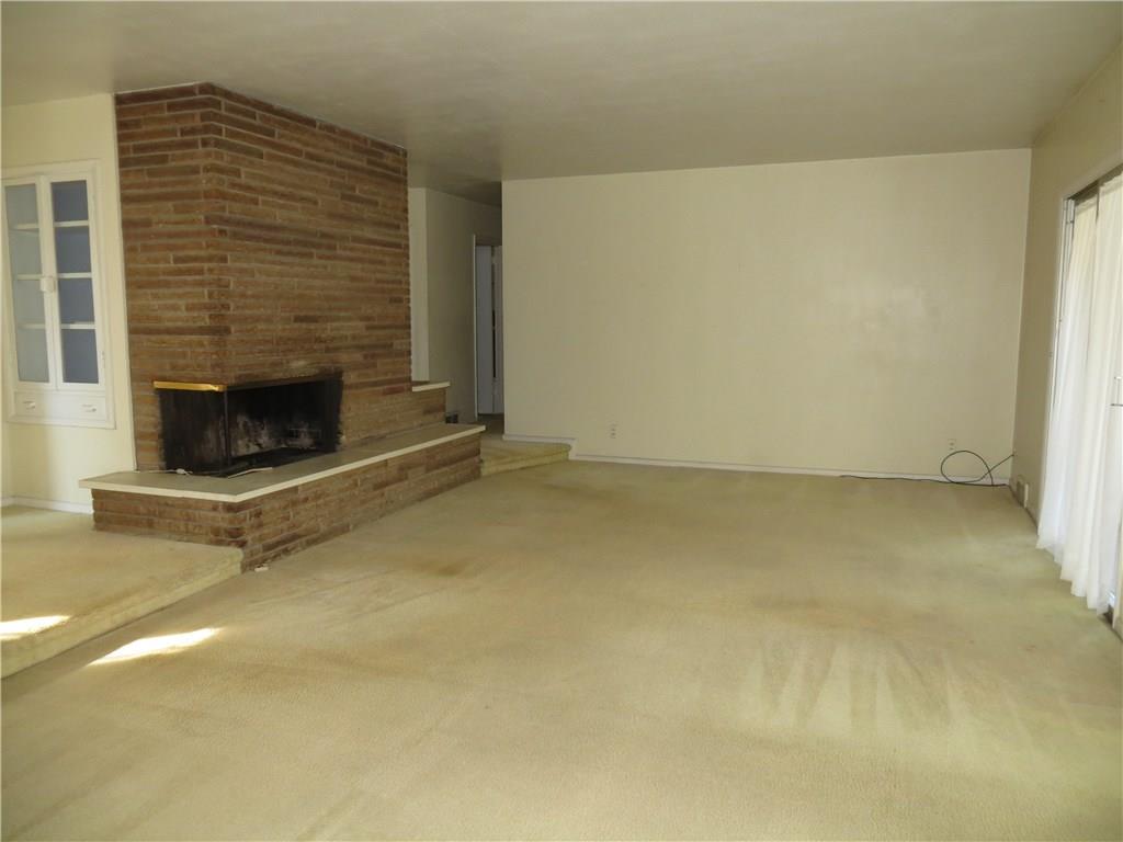 3974 Patterson Road Aliquippa, PA 15001 - Photo 5 of 14 Living Room with Cozy Corner Log Burning Fireplace.
