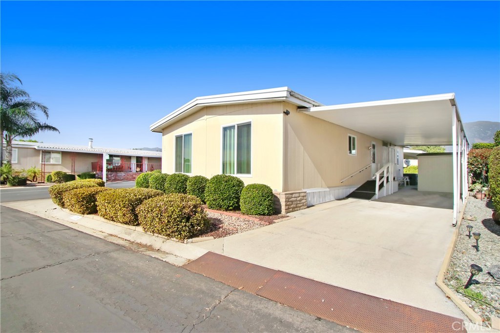 10210 Base Line Road, Unit 173 Rancho Cucamonga, CA 91701 - Photo 2 of 17 a front view of a house with a yard