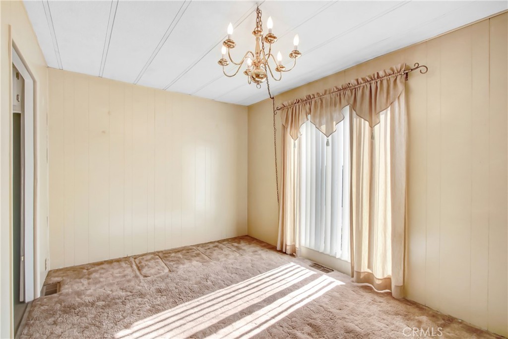 10210 Base Line Road, Unit 173 Rancho Cucamonga, CA 91701 - Photo 5 of 17 a view of a room with a chandelier and a window