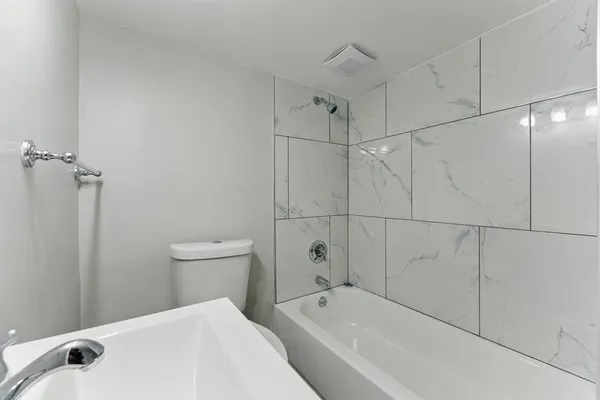 a bathroom with a bathtub and toilet