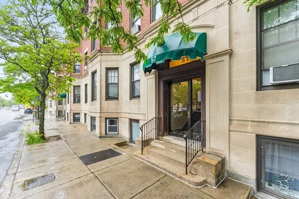 a view of a patio with a table and chairs and potted plants