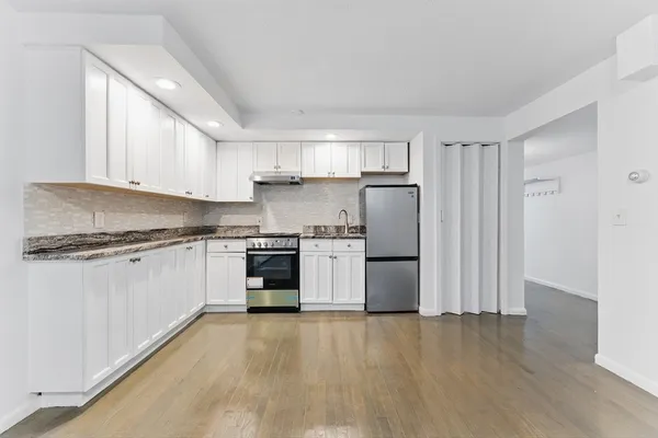 a kitchen with a white cabinets and white appliances