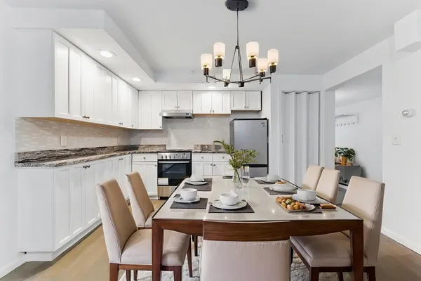 a view of a dining room and a kitchen counter top space