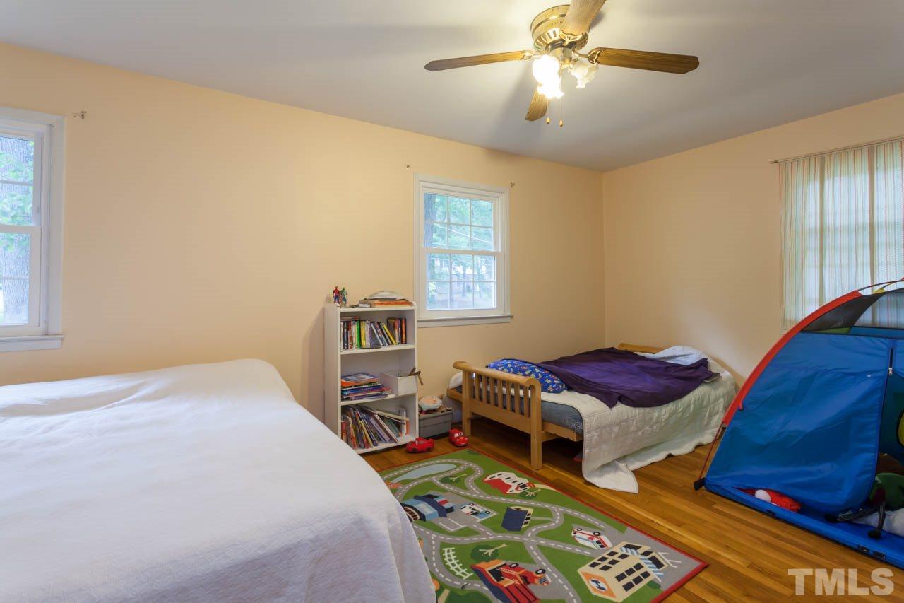 1733 Euclid Road Durham, NC 27713 - Photo 20 of 25 a bedroom with bed and a chandelier