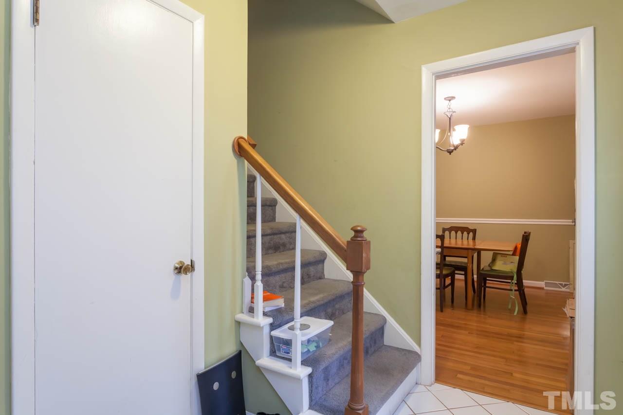1733 Euclid Road Durham, NC 27713 - Photo 6 of 25 a view of a hallway with wooden floor and stairs