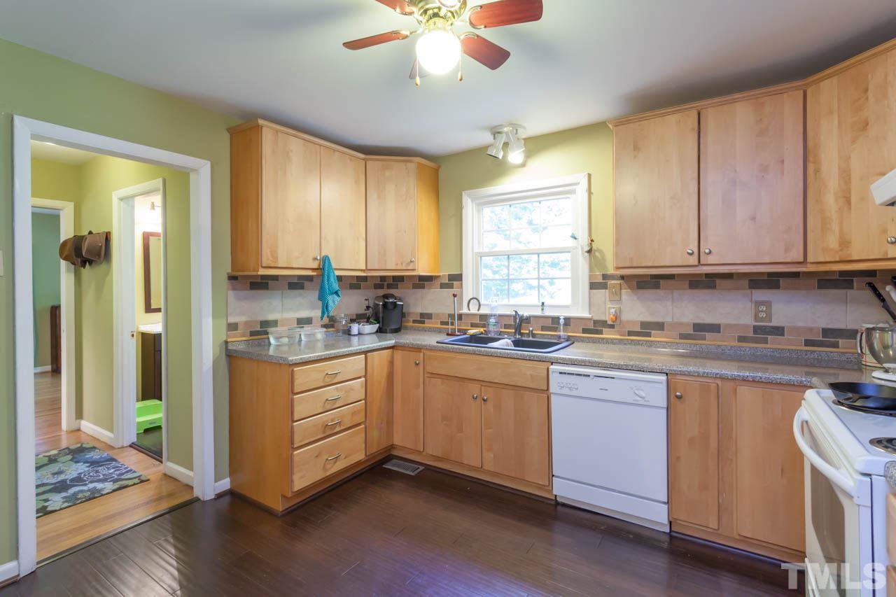1733 Euclid Road Durham, NC 27713 - Photo 9 of 25 a kitchen with stainless steel appliances granite countertop a sink a stove cabinets and wooden floor