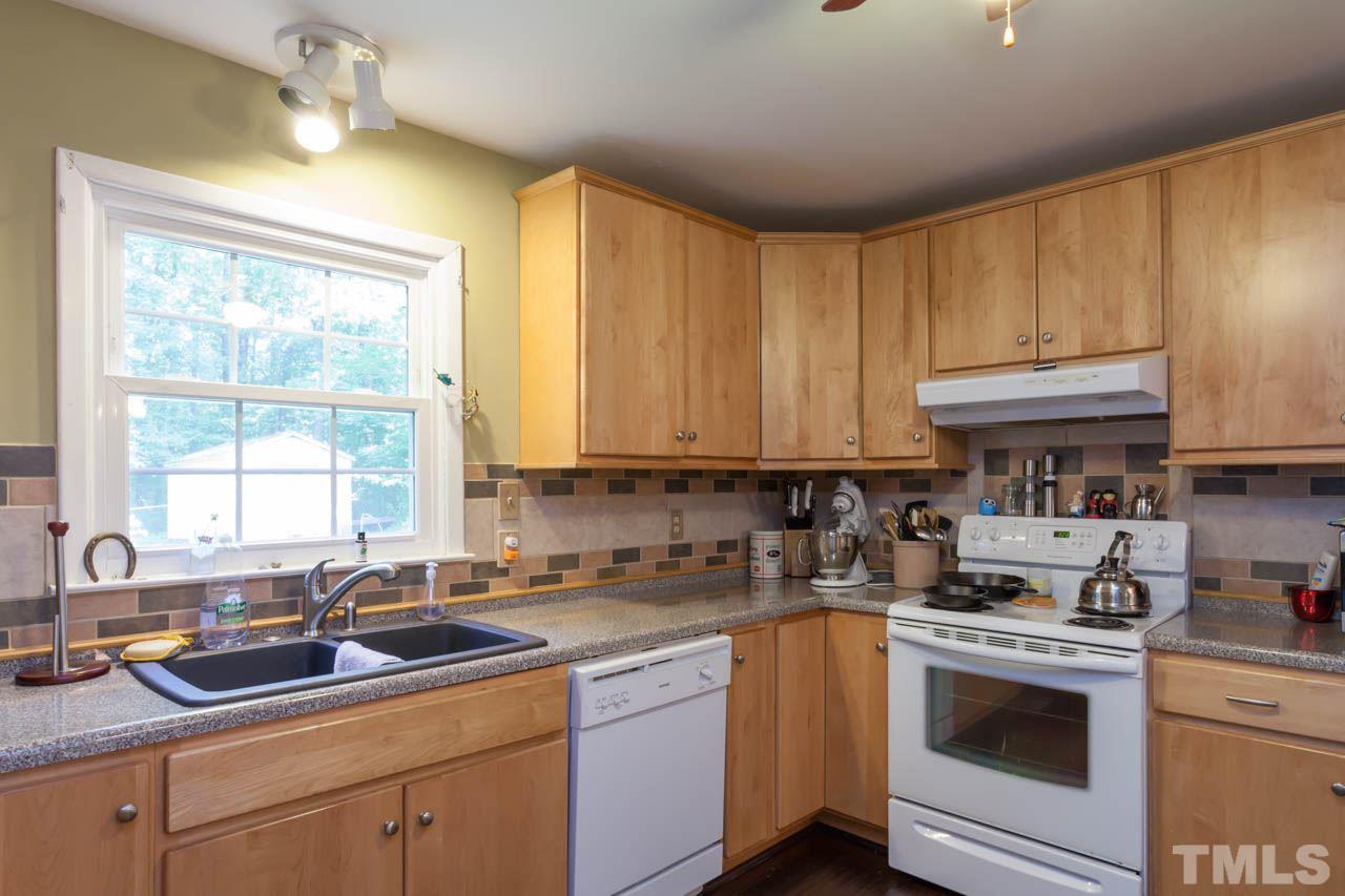 1733 Euclid Road Durham, NC 27713 - Photo 10 of 25 a kitchen with a sink stove top oven and cabinets
