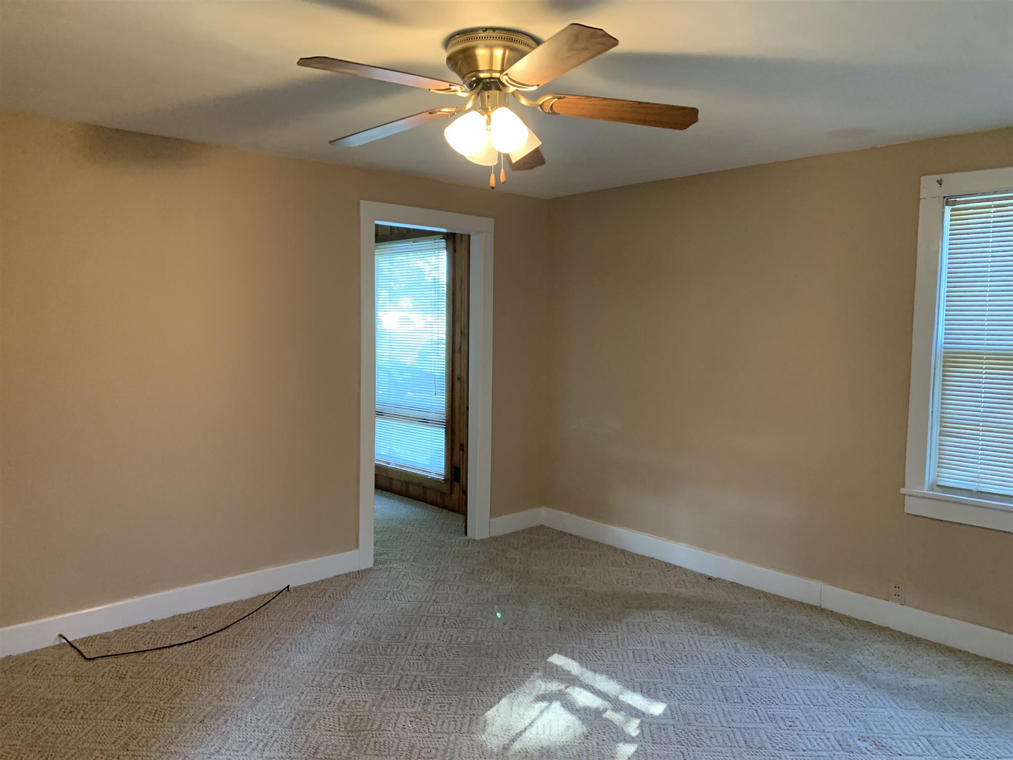 1303 Academy Road Portland, TN 37148 - Photo 13 of 30 an empty room with windows and fan
