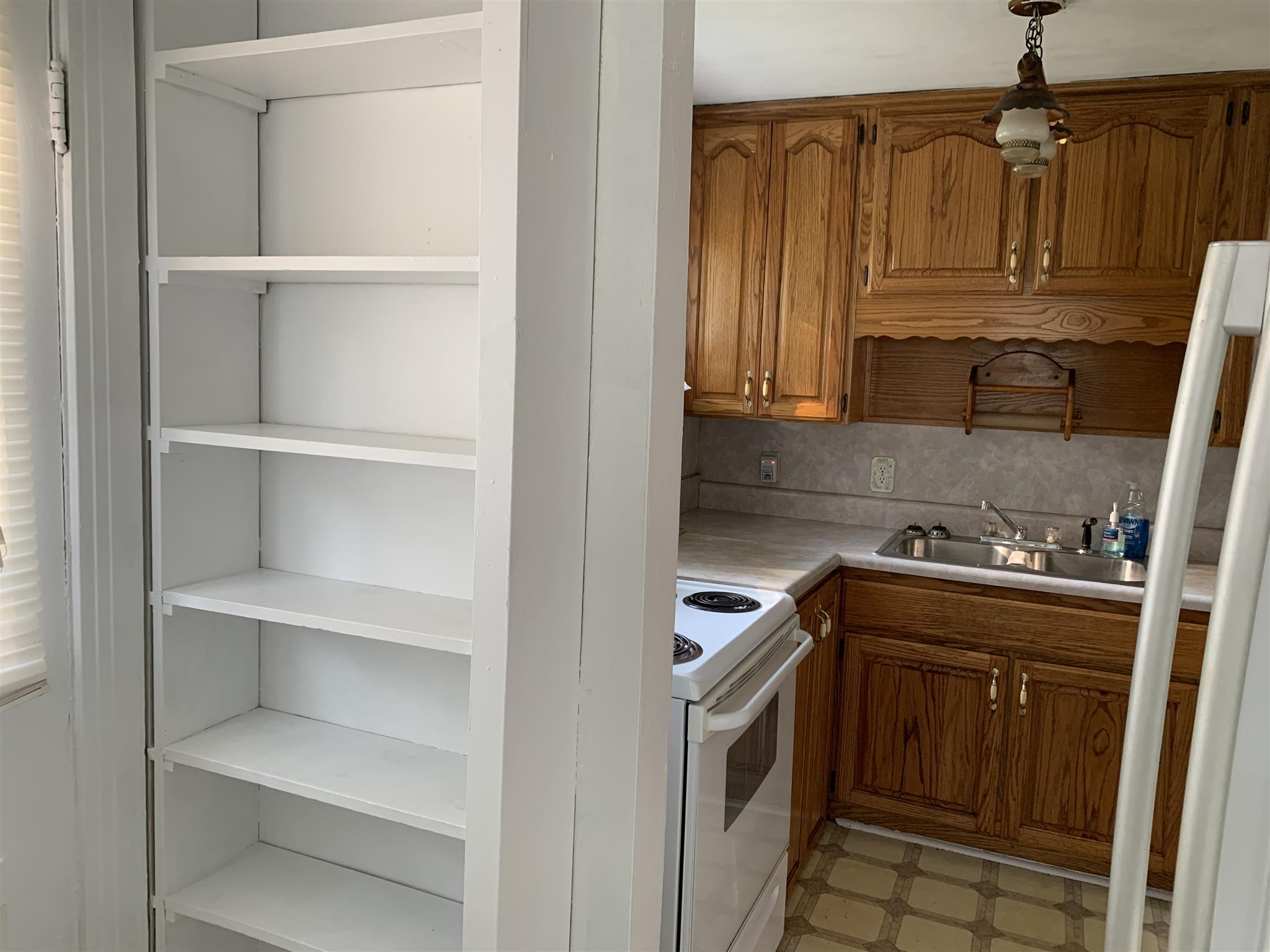 1303 Academy Road Portland, TN 37148 - Photo 23 of 30 a kitchen with white cabinets and stainless steel appliances