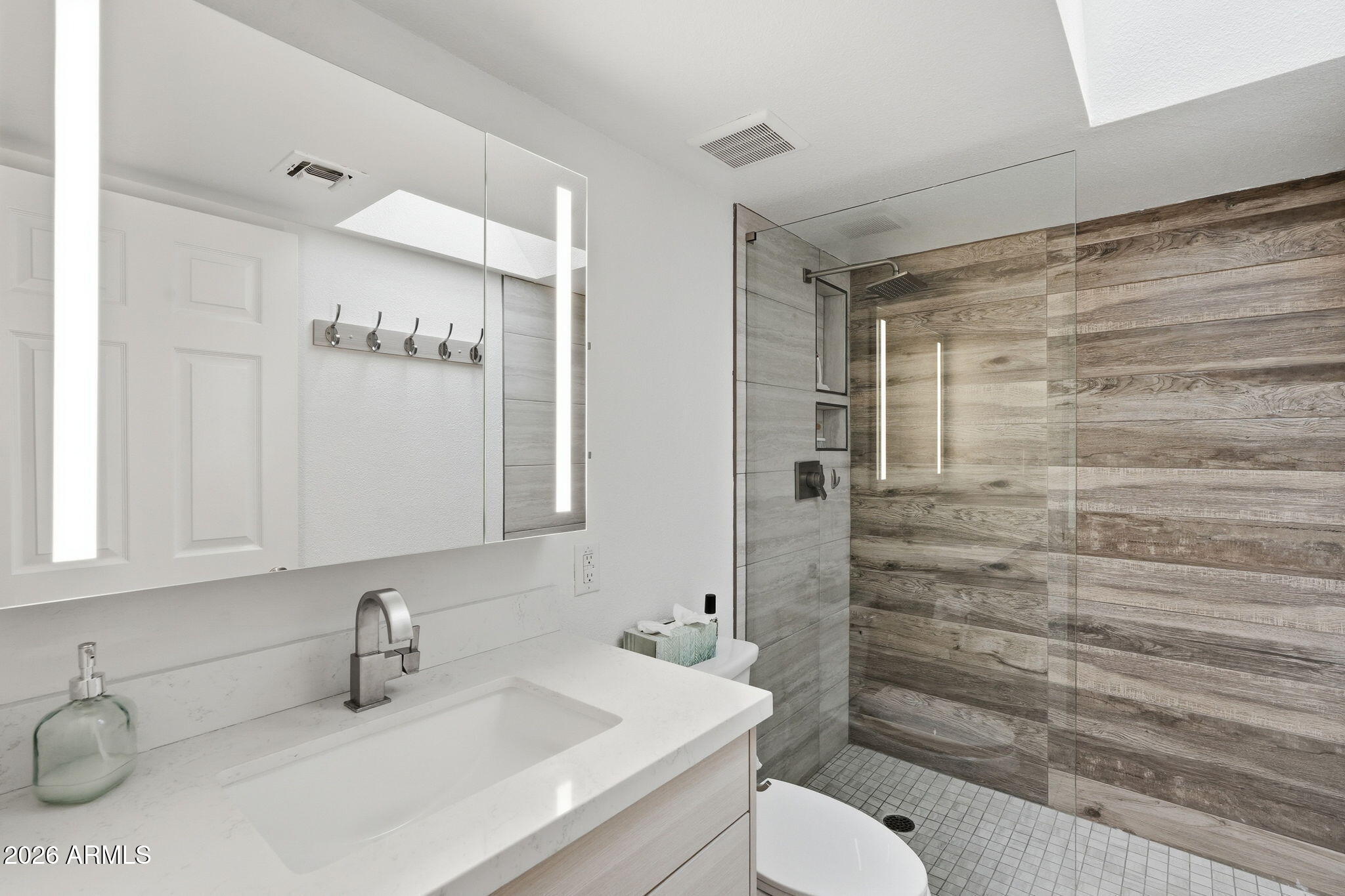 4201 East Camelback Road, Unit 34 Phoenix, AZ 85018 - Photo 12 of 19 a bathroom with a sink toilet and shower
