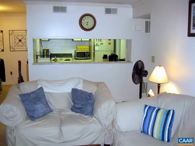 a living room with a couch and a wall painting