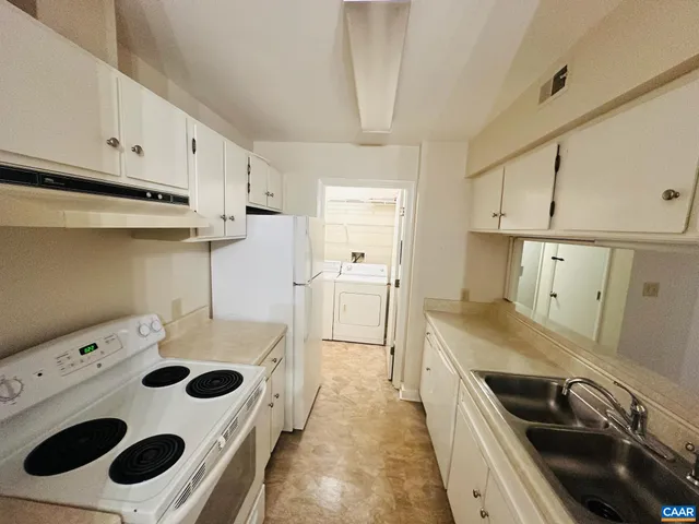 a kitchen with a sink a stove and refrigerator