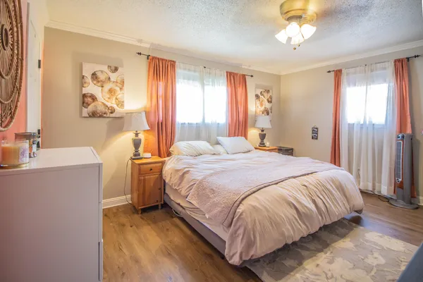 a bedroom with a large bed and a chandelier