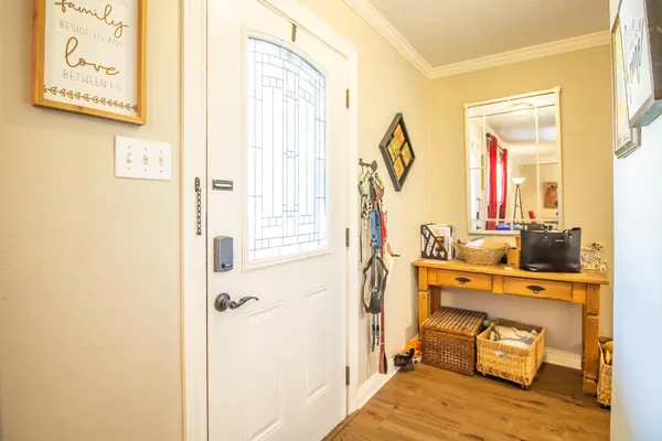a view of a bedroom with a bed and wooden floor