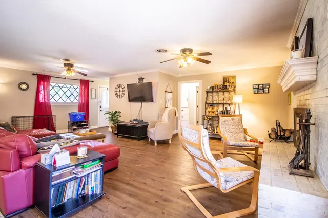 a bedroom with furniture a flat screen tv and a window