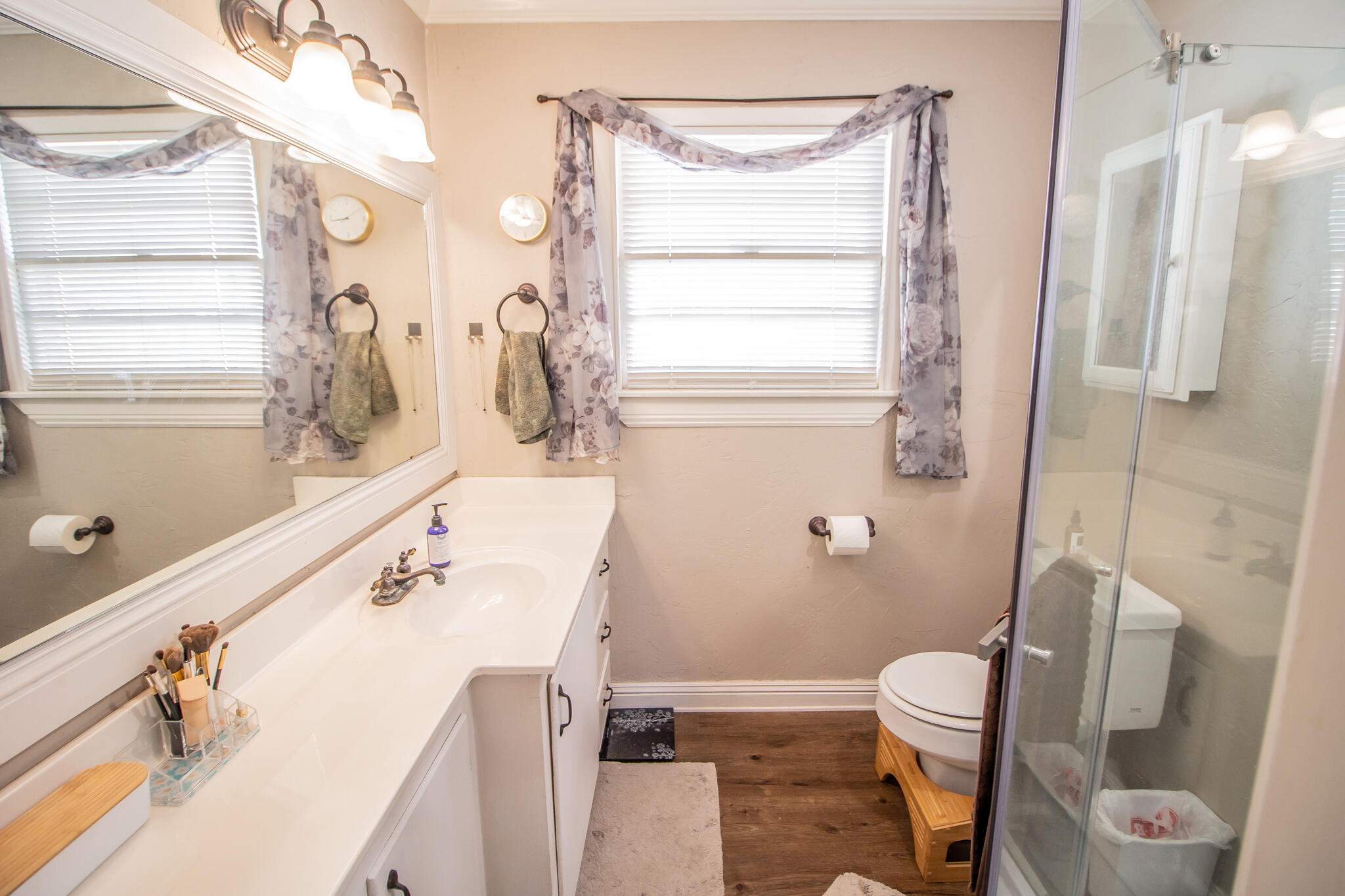 5219 9th Street Lubbock, TX 79416 - Photo 2 of 23 a bathroom with a sink a toilet and shower curtain