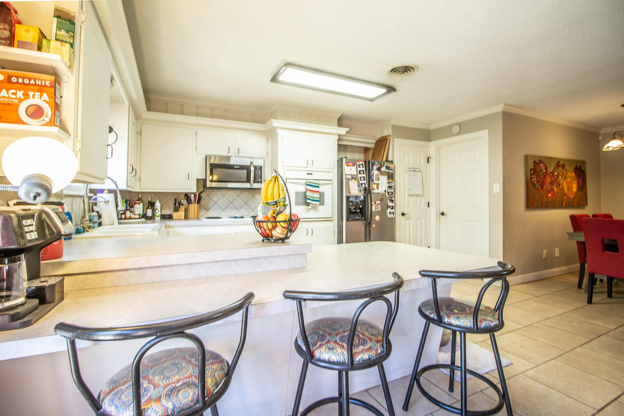 5219 9th Street Lubbock, TX 79416 - Photo 22 of 23 a view of a dining room with furniture and a chandelier
