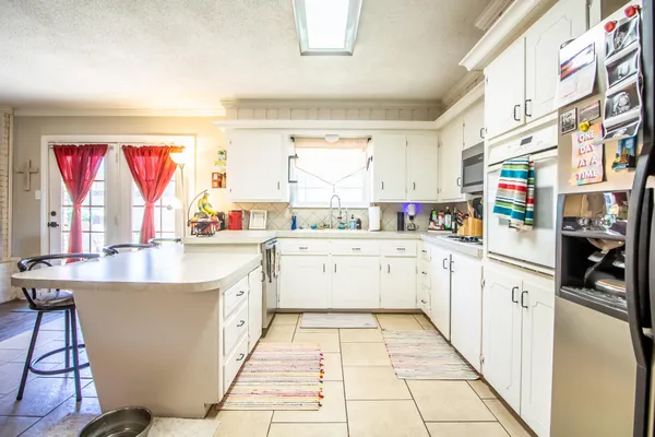 a kitchen with stainless steel appliances granite countertop a sink and cabinets
