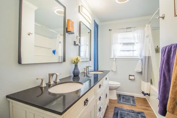 a bathroom with a sink a toilet and a mirror