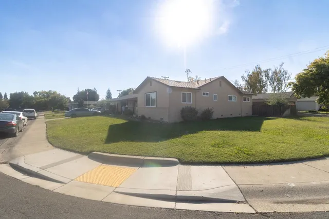 a view of a house with a yard and a fountain