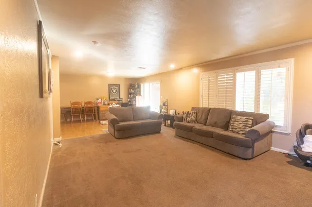 a view of a porch with furniture and a yard