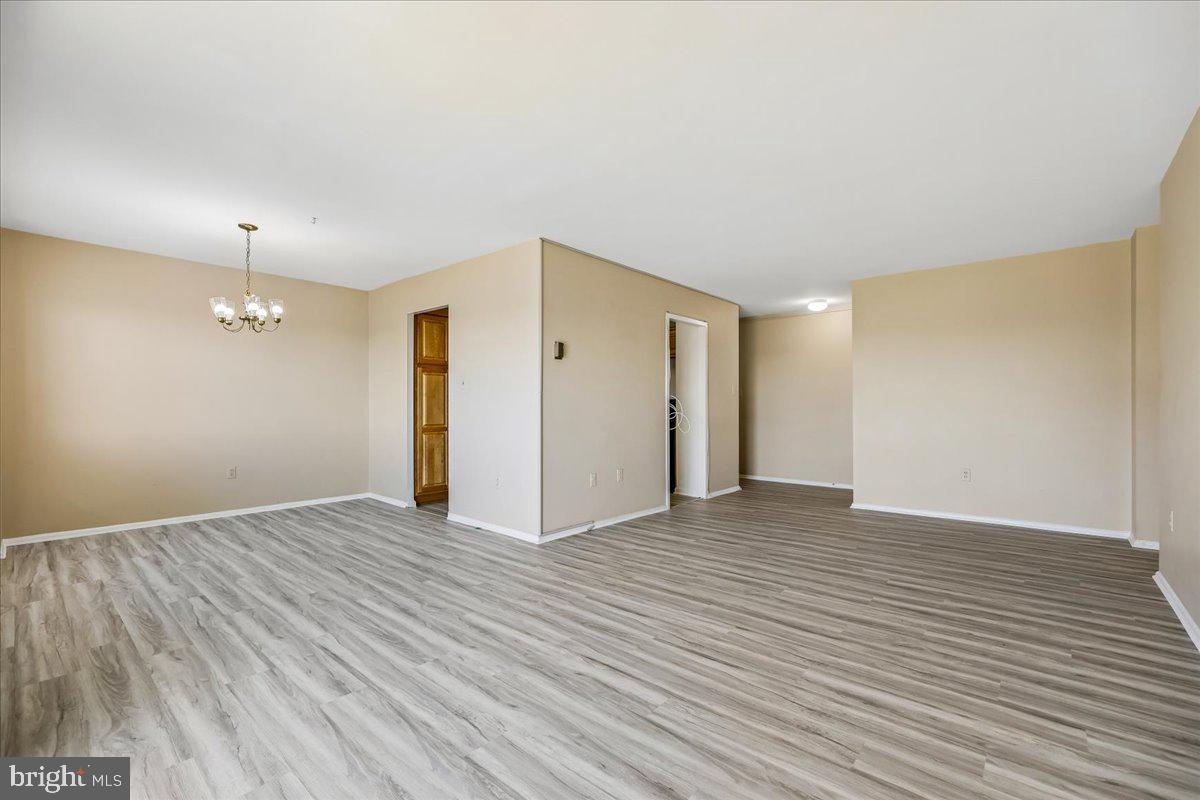 1111 University Boulevard West, Unit 1106A Silver Spring, MD 20902 - Photo 5 of 35 a view of an empty room with wooden floor