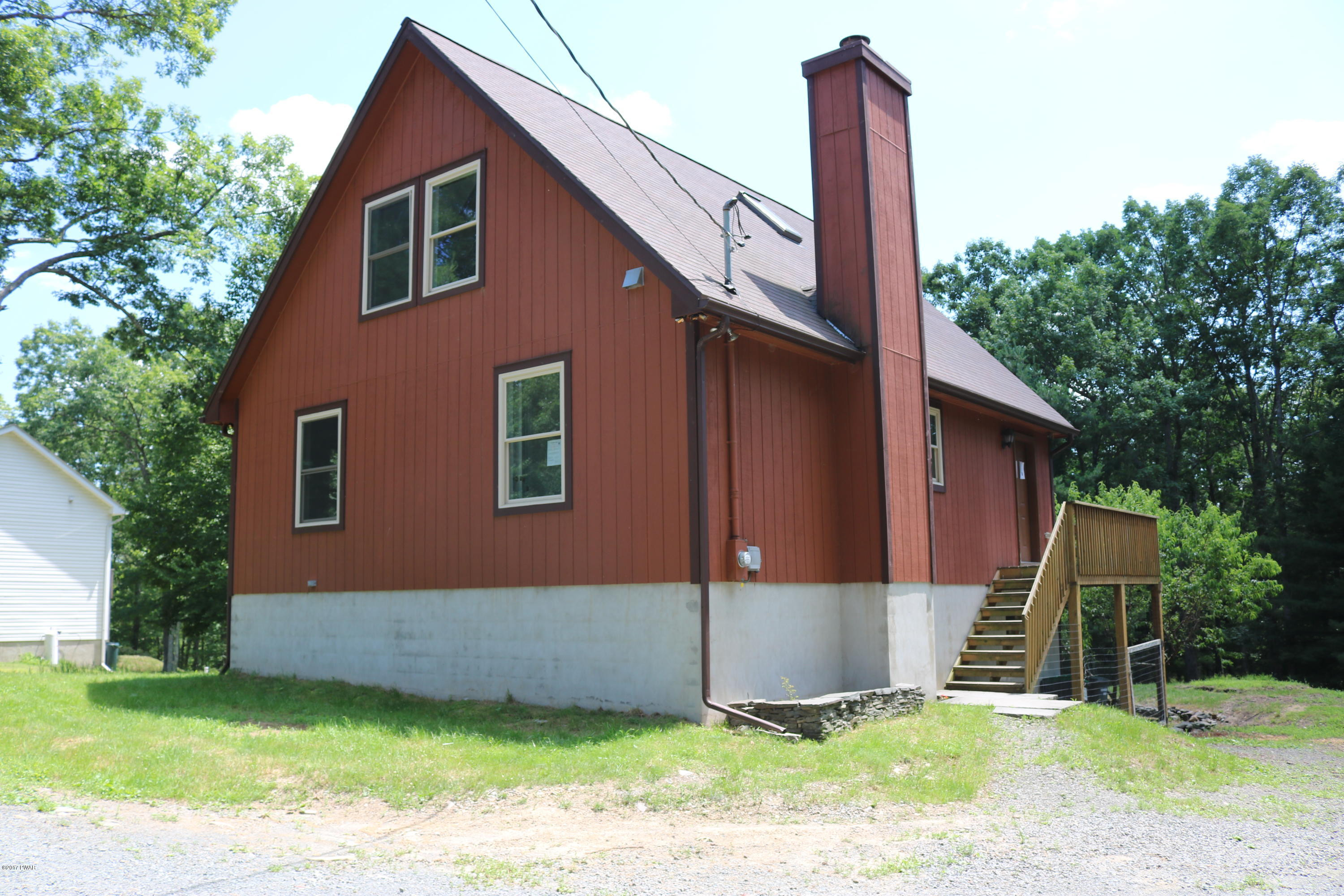 181 Butternut Road Milford, PA 18337 - Photo 5 of 26 a front view of a house with a garden and yard