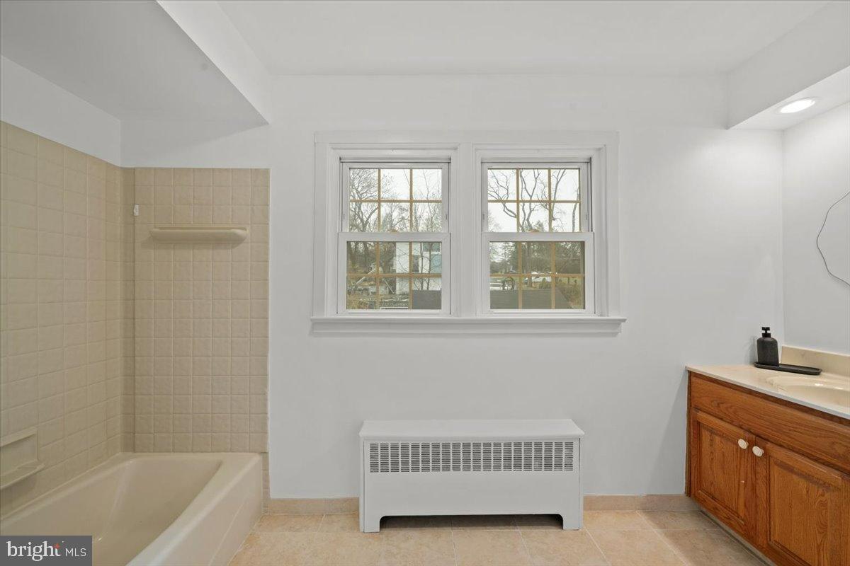 3349 Brodhead Road Bethlehem, PA 18020 - Photo 33 of 53 a bathroom with a sink a bathtub and a window