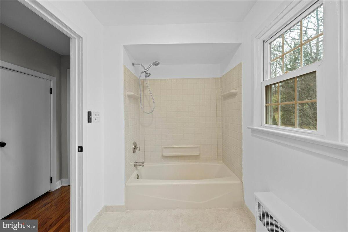3349 Brodhead Road Bethlehem, PA 18020 - Photo 34 of 53 a bathroom with a bathtub shower and a window