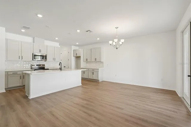 a kitchen with appliances a sink and cabinets