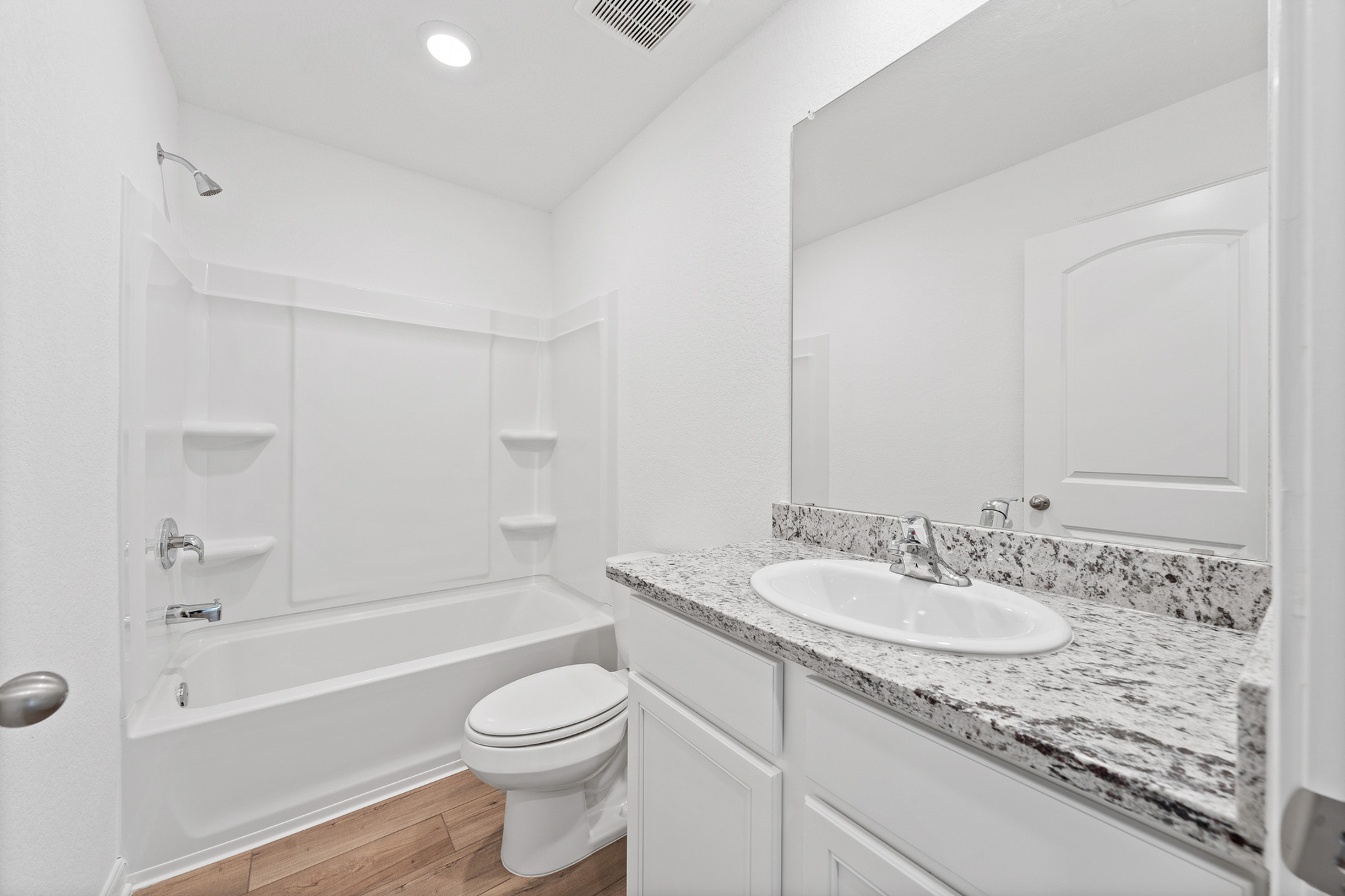 402 Aplite Pass Maxwell, TX 78656 - Photo 6 of 6 Full bath with vanity, light wood-style floors, and bathing tub / shower combination