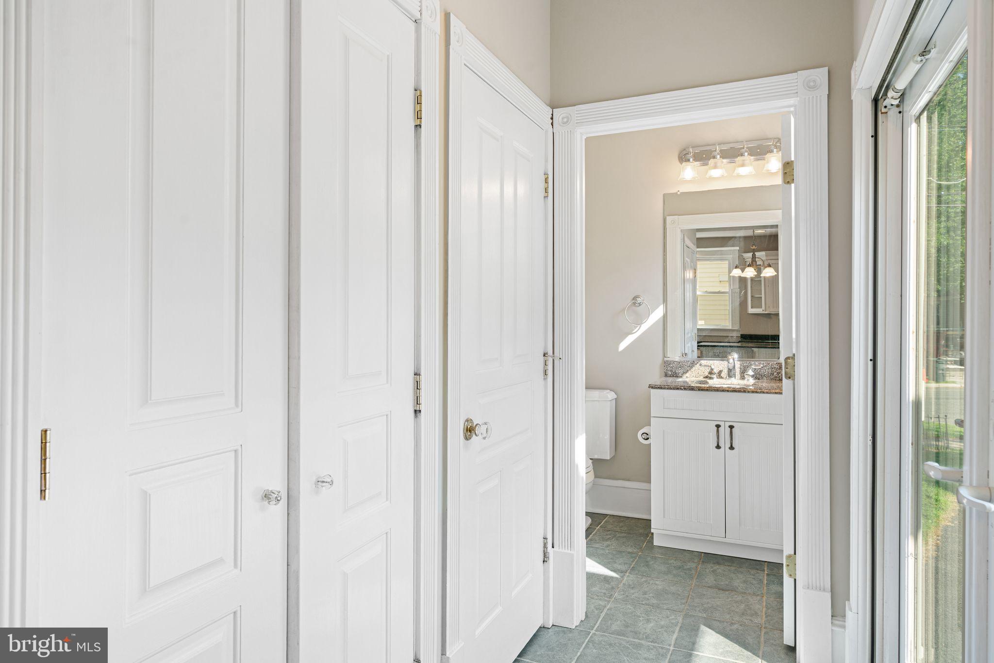 47 Estaugh Avenue Haddonfield, NJ 08033 - Photo 18 of 19 a bathroom with a granite countertop sink a mirror and a vanity