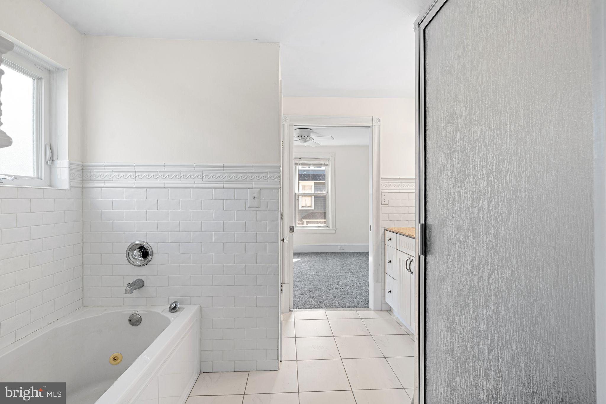 47 Estaugh Avenue Haddonfield, NJ 08033 - Photo 8 of 19 a bathroom with a bathtub and a shower