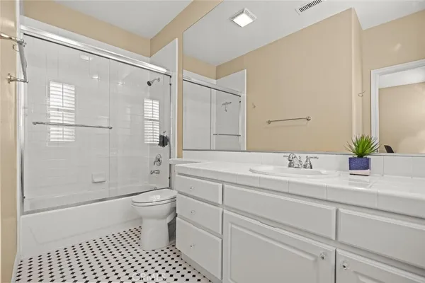 a bedroom with a bed a desk and chair