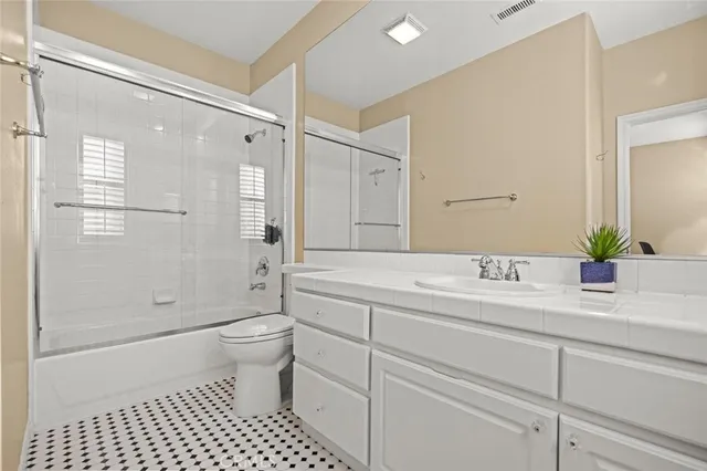 a bedroom with a bed a desk and chair