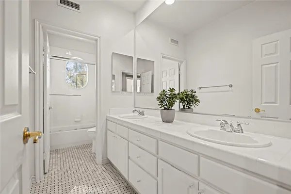 a spacious bedroom with a bed a fireplace and a large window