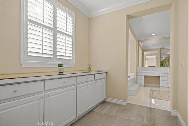 a bathroom with a double vanity sink bathtub and next to a window